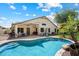 Beautiful backyard featuring a sparkling pool, covered patio, lush landscaping, and ample seating at 420 S Dodge Dr, Chandler, AZ 85225