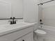 Bright bathroom features white cabinets, modern fixtures, and a tub shower combo at 42405 W Peters Dr, Maricopa, AZ 85138