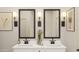 Bright bathroom featuring dual sinks, modern fixtures, decorative sconces, and stylish design elements at 42405 W Peters Dr, Maricopa, AZ 85138