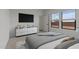 Bright bedroom with modern dresser, TV, and windows providing ample natural light at 42405 W Peters Dr, Maricopa, AZ 85138