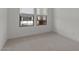 Carpeted bedroom with windows and light interior at 42405 W Peters Dr, Maricopa, AZ 85138