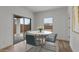 Cozy dining area with wood-look floors, natural light, and access to the outdoor patio at 42405 W Peters Dr, Maricopa, AZ 85138