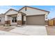 Charming single-story home featuring a two-car garage, covered porch, and low maintenance desert landscaping at 42405 W Peters Dr, Maricopa, AZ 85138