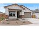 Charming single-story home featuring a two-car garage, covered porch, and low maintenance desert landscaping at 42405 W Peters Dr, Maricopa, AZ 85138