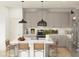 Modern kitchen featuring gray cabinets, stainless steel appliances, a large island, and stylish pendant lighting at 42405 W Peters Dr, Maricopa, AZ 85138