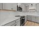 Bright kitchen featuring stainless steel appliances, white subway tile backsplash, and grey cabinets at 42405 W Peters Dr, Maricopa, AZ 85138