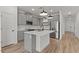 Modern kitchen with grey cabinetry, stainless steel appliances, a center island, and wood-look tile flooring at 42405 W Peters Dr, Maricopa, AZ 85138