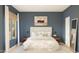 Serene main bedroom with a large bed, stylish decor, soft lighting, and a peaceful ambiance at 42405 W Peters Dr, Maricopa, AZ 85138