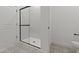 Contemporary bathroom shower with sleek glass enclosure and stylish patterned floor tiles at 42405 W Peters Dr, Maricopa, AZ 85138