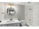 Bathroom features a new light fixture, round mirror, and luxurious marble tile at 4610 N 68Th St # 409, Scottsdale, AZ 85251