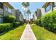 Landscaped walkway between apartment buildings with lush green lawns and palm trees at 4610 N 68Th St # 409, Scottsdale, AZ 85251