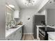 Modern kitchen with stainless steel appliances, white cabinets, marble countertops, and stylish gold fixtures at 4610 N 68Th St # 409, Scottsdale, AZ 85251