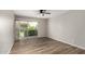Bright, empty living room featuring wood floors and a sliding glass door to the patio at 4610 N 68Th St # 409, Scottsdale, AZ 85251