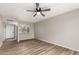 Bright, empty living room with wood floors and an open view into the kitchen at 4610 N 68Th St # 409, Scottsdale, AZ 85251