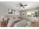 Serene bedroom featuring a ceiling fan, neutral color palette, natural light, and minimalist decor at 4610 N 68Th St # 409, Scottsdale, AZ 85251