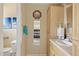 This bathroom sink has oak cabinets and is next to a room with a bed visible in the mirror at 4613 E Shangri La Rd --, Phoenix, AZ 85028