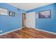 Blue bedroom featuring wood floors, a spacious closet, and a serene ambiance for restful nights at 4613 E Shangri La Rd --, Phoenix, AZ 85028