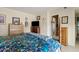 Comfortable bedroom with tiled floors, a dresser and bed with bright floral bedding at 4613 E Shangri La Rd --, Phoenix, AZ 85028