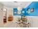 Charming dining area featuring a round table, patterned chairs, and stylish decor against a vibrant blue accent wall at 4613 E Shangri La Rd --, Phoenix, AZ 85028