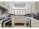 Bright kitchen with white cabinets, stainless steel appliances, and stylish backsplash at 4613 E Shangri La Rd --, Phoenix, AZ 85028
