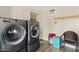 Modern laundry room with gray front load washer and dryer on gray laminate wood flooring at 4613 E Shangri La Rd --, Phoenix, AZ 85028