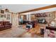 Spacious living room features a brick fireplace, wood beams, and comfortable leather seating, creating a cozy atmosphere at 4613 E Shangri La Rd --, Phoenix, AZ 85028