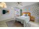 Bright bedroom featuring unique wallpaper, ceiling fan, and private outdoor access at 4620 N 38Th Dr, Phoenix, AZ 85019