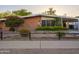 Charming brick home with colorful landscaping, wood fence, and covered carport at 4620 N 38Th Dr, Phoenix, AZ 85019