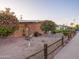 Charming front yard features decorative rock, lush trees, and a quaint wooden fence at 4620 N 38Th Dr, Phoenix, AZ 85019