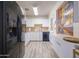 Well-lit kitchen with white cabinets, black appliances, and unique window feature at 4620 N 38Th Dr, Phoenix, AZ 85019
