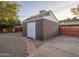 Exterior shot of shed with white double doors and concrete and gravel walkway at 4620 N 38Th Dr, Phoenix, AZ 85019