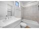 Bright bathroom featuring a single sink, a toilet, a bath tub with shower, and a window at 5311 N 88Th Ave, Glendale, AZ 85305