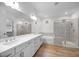Modern bathroom with double vanity, soaking tub, glass-enclosed shower, and stylish tile work at 5311 N 88Th Ave, Glendale, AZ 85305
