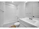 Bright bathroom featuring a single sink, a toilet, and a bath tub with shower at 5311 N 88Th Ave, Glendale, AZ 85305