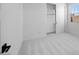 Bright bedroom featuring neutral carpeting, a partially open closet with sliding doors, and a window at 5311 N 88Th Ave, Glendale, AZ 85305