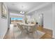 Elegant dining area with wood floors and a stylish chandelier fixture at 5311 N 88Th Ave, Glendale, AZ 85305