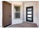 Modern front entry with a stylish door and a sidelight window for natural light at 5311 N 88Th Ave, Glendale, AZ 85305