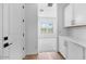 Hallway with modern cabinets and a view of the living area through large windows at 5311 N 88Th Ave, Glendale, AZ 85305