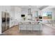 Bright kitchen features a large island with seating, stainless appliances, and white cabinetry at 5311 N 88Th Ave, Glendale, AZ 85305