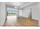 Open-concept living area with bright wood floors and large glass doors leading outside at 5311 N 88Th Ave, Glendale, AZ 85305