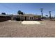 Rear view of home featuring desert landscaping, concrete patios, and fenced yard at 5815 N 21St Ave, Phoenix, AZ 85015