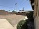 Spacious gravel backyard with block fence and lush shrubbery along the home at 5815 N 21St Ave, Phoenix, AZ 85015