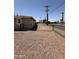 View of gravel backyard with block and chain link fencing offering security and privacy at 5815 N 21St Ave, Phoenix, AZ 85015