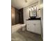 Bathroom featuring a copper accent tiled shower, modern vanity with vessel sink, and plank flooring at 5815 N 21St Ave, Phoenix, AZ 85015