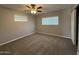 This bedroom features neutral walls, plush carpeting, two windows and a ceiling fan with light fixture at 5815 N 21St Ave, Phoenix, AZ 85015
