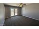 Bedroom with neutral walls, carpet, French doors leading outside and a ceiling fan with light fixture at 5815 N 21St Ave, Phoenix, AZ 85015