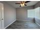 Bedroom featuring new gray flooring and a modern ceiling fan at 5815 N 21St Ave, Phoenix, AZ 85015