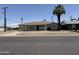 Charming single-story home with a brown roof, tidy landscaping, and a mature palm tree in the front yard at 5815 N 21St Ave, Phoenix, AZ 85015