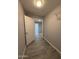 Hallway featuring updated tile flooring, neutral paint, and ample lighting at 5815 N 21St Ave, Phoenix, AZ 85015