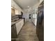 Updated kitchen with stainless steel appliances, granite counters, white cabinets, and stylish backsplash at 5815 N 21St Ave, Phoenix, AZ 85015
